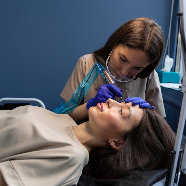 Young woman getting a beauty treatment for her eyebrows