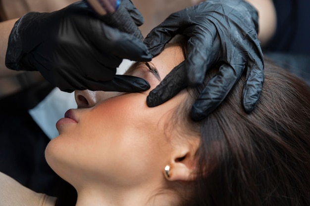 Young woman getting a beauty treatment for her eyebrows