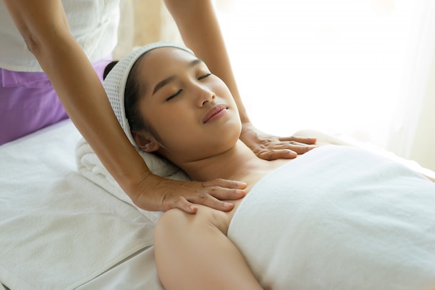 Young woman getting body massage at spa.