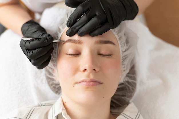 Young woman getting an eyebrow treatment at the beauty salon