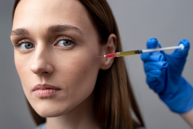 Free photo young woman getting prp therapy