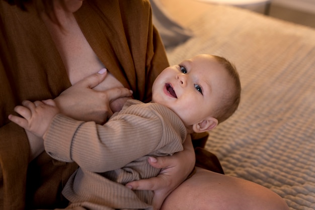 Young woman getting ready to breastfeed her baby