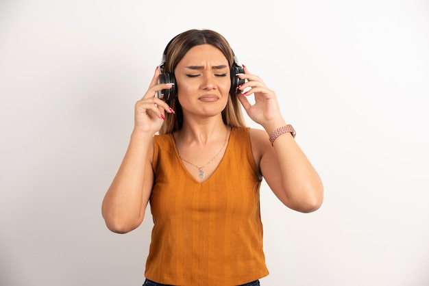 Free photo young woman girl in casual clothes posing with headphones.