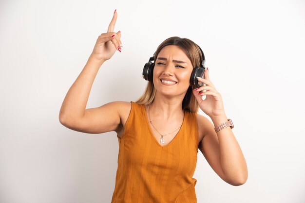 Young woman girl in casual clothes posing with headphones.