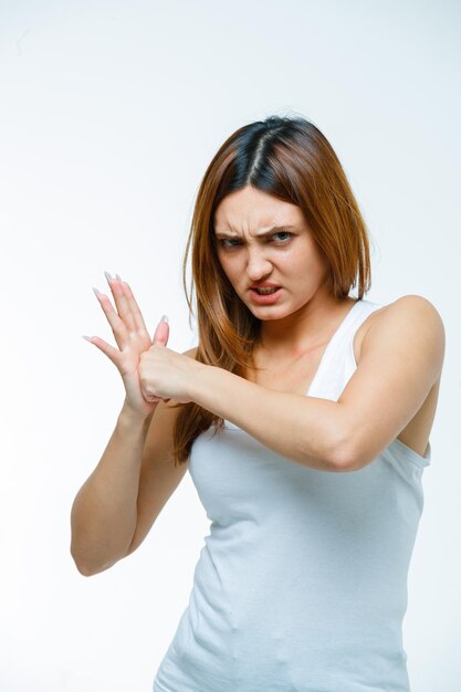 Young woman giving punching her palm and looking aggressive