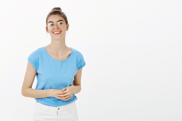 Young woman in glasses looking pleased, ready for business