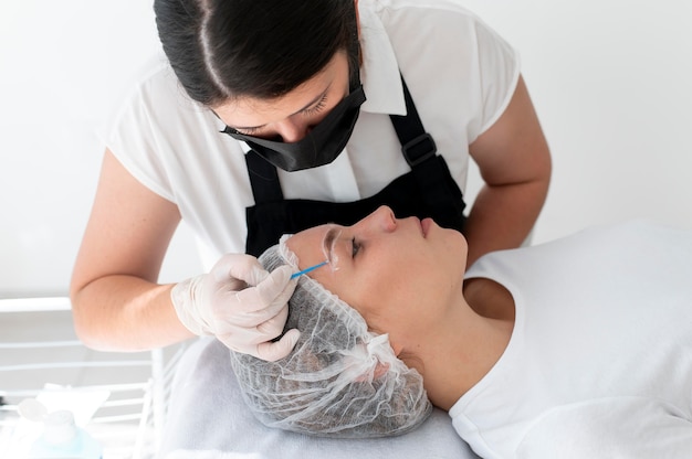 Young woman going through a microblading procedure