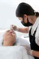 Free photo young woman going through a microblading procedure