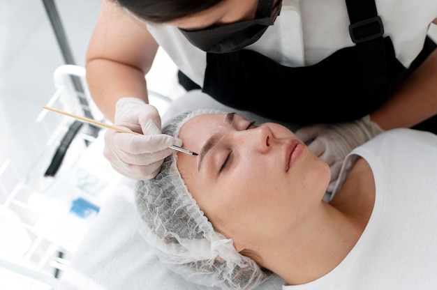 Young woman going through a microblading procedure