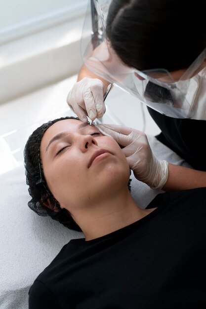 Young woman going through a microblading procedure