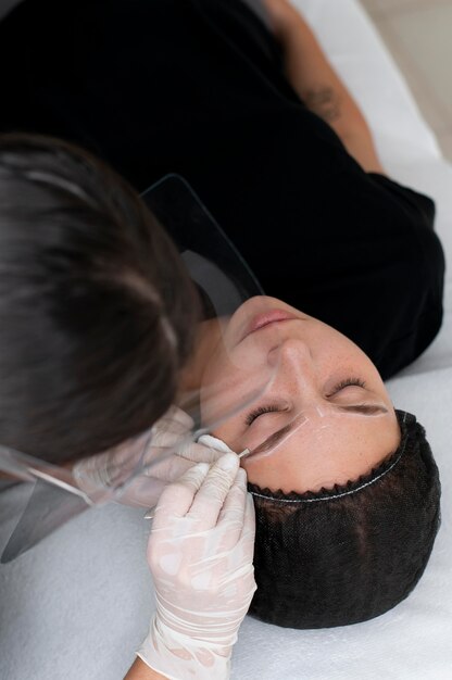 Young woman going through a microblading procedure