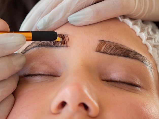 Young woman going through a microblading procedure