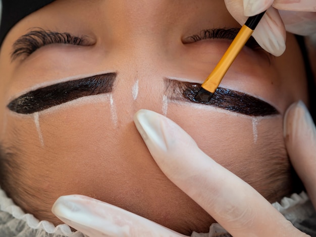 Young woman going through a microblading procedure