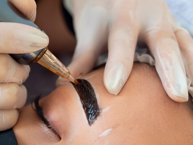 Young woman going through a microblading procedure