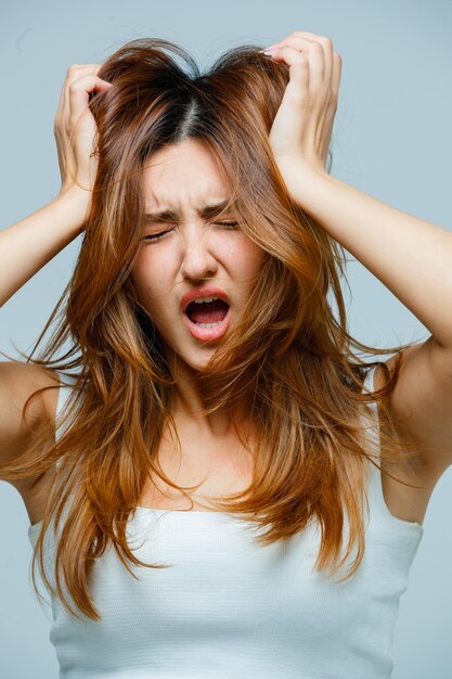 Young woman grabbing her hair