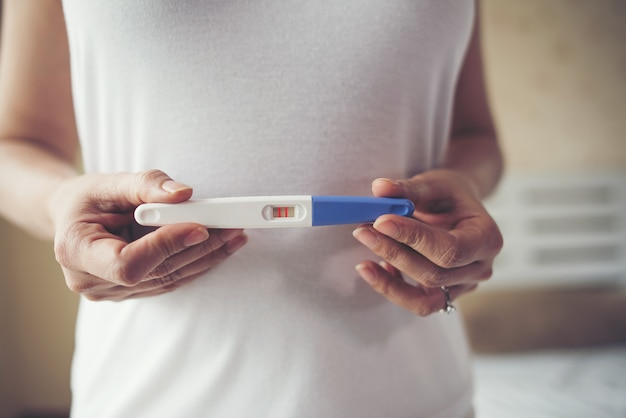 Free photo young woman hand holding pregnancy test