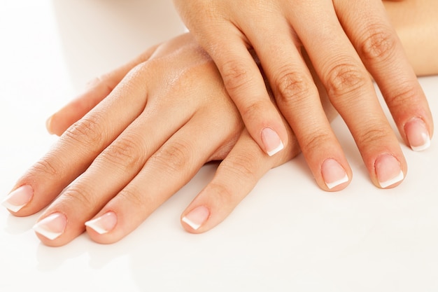 Young woman hands with french manicure 