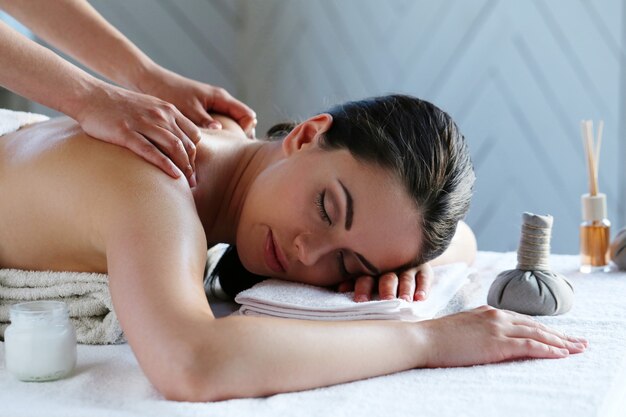 Young woman having back and shoulder massage