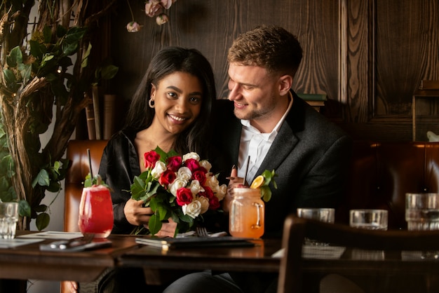 Free photo young woman having a bouquet of roses from her boyfriend