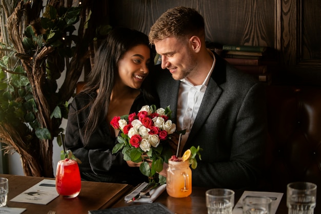 Free photo young woman having a bouquet of roses from her boyfriend