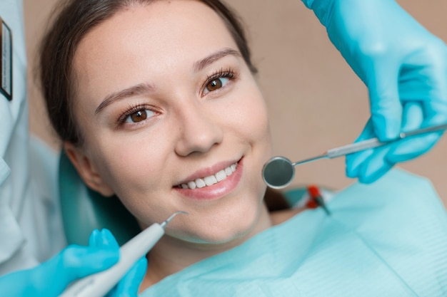 Young woman having dental treatment at dentists office