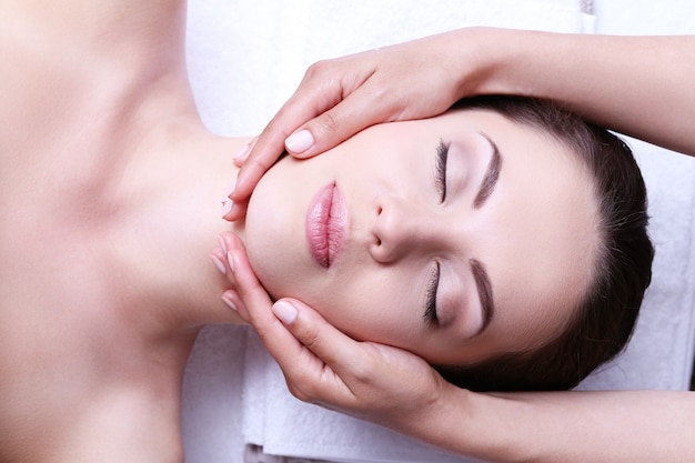 Young woman having face massage