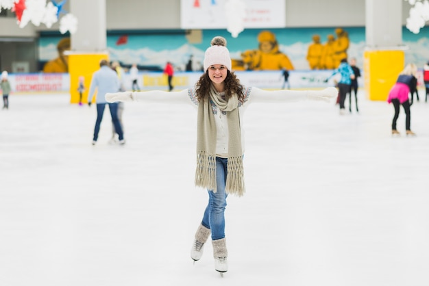 Young woman having fun on skating rink