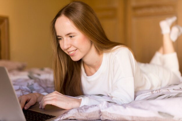 Young woman having fun with her laptop