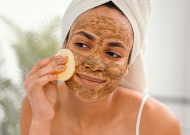 Young woman having a homemade mask on her face