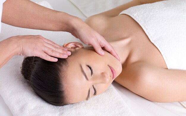 Young woman having massage for the skin of her beautiful face