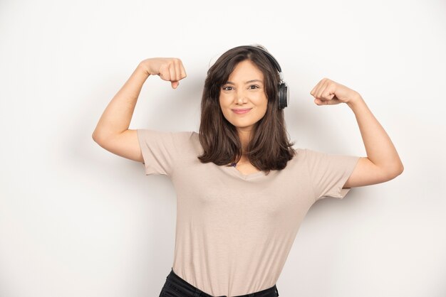 Young woman in headphones on white background.