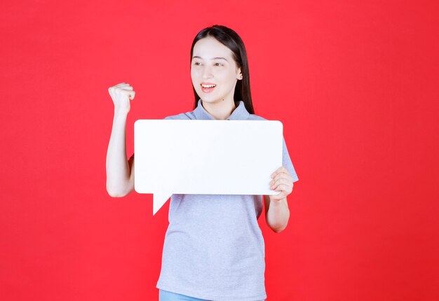 Young woman holding board and squeeze her fist