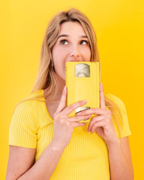 Young woman holding cassette