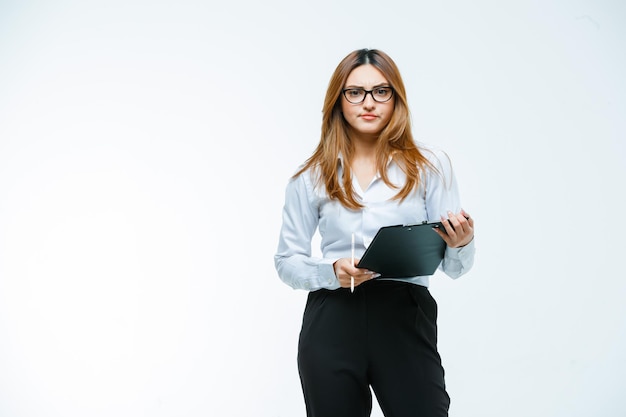 Young woman holding clipboard and pen