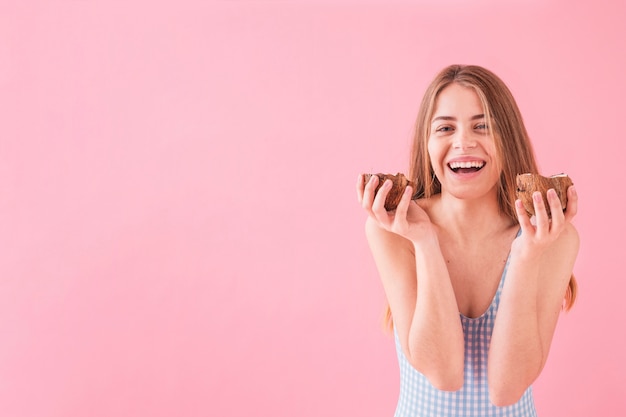 Young woman holding coconut