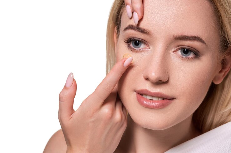 Free Photo young woman holding contact lens on index finger with copy space. close up face of healthy beautiful woman about to wear contact lens. eyesight and ophthalmology concept.