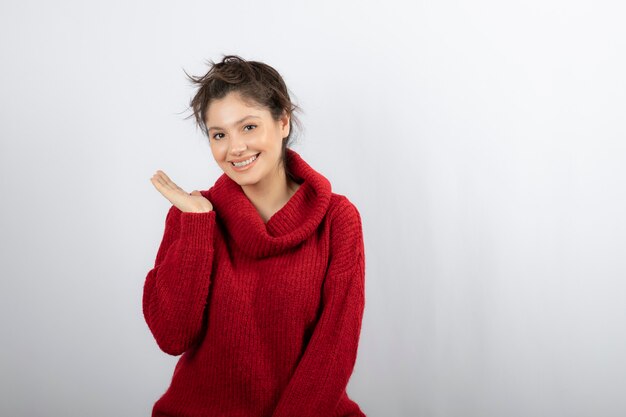 Young woman holding copy space on a palm. 