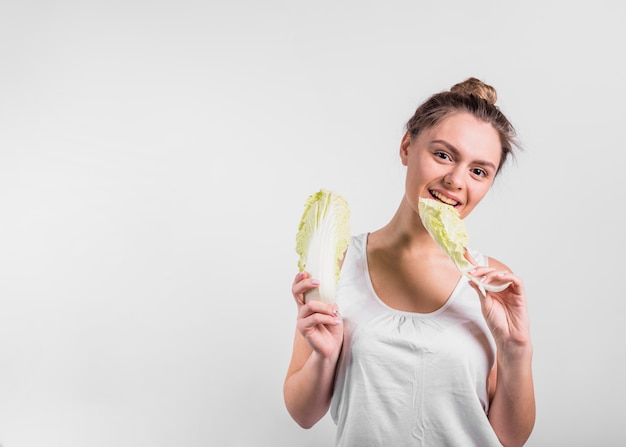 Young woman holding fresh cabbage