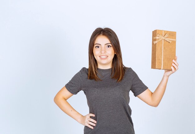 young woman holding a gift box .