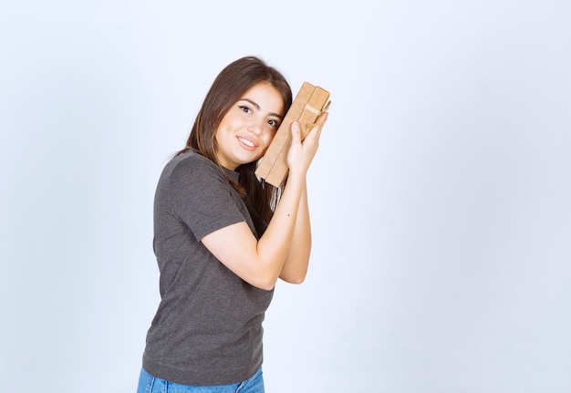 young woman holding a gift box .