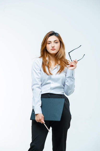 Young woman holding glasses while posing