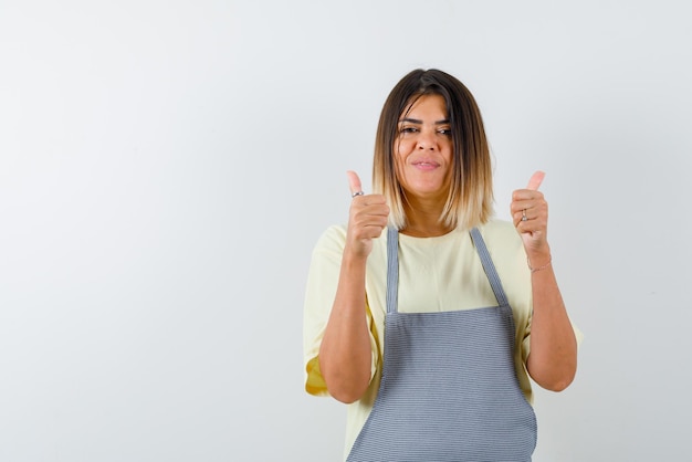 Young woman holding a good hand gesture on white background