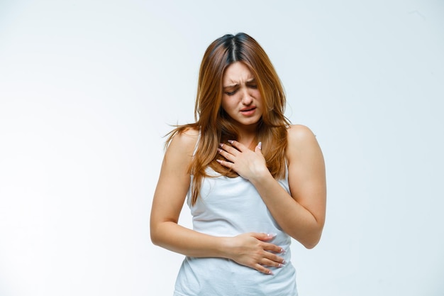 Young woman holding hand on chest