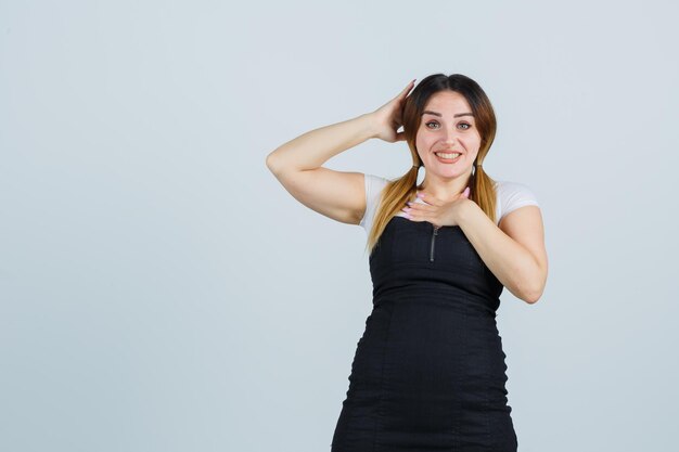 Young woman holding hands on chest and head