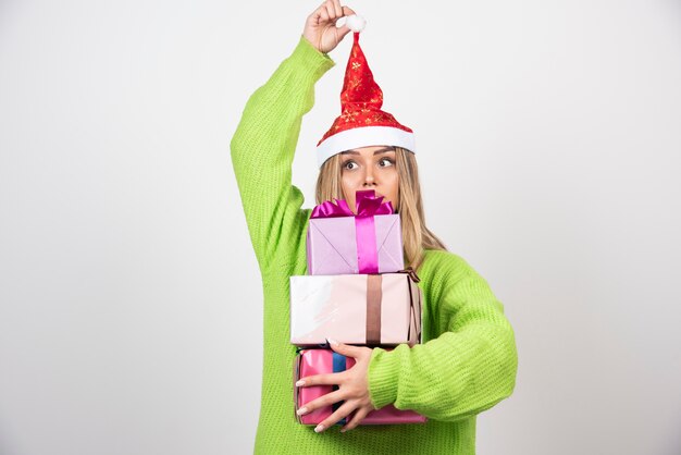 Young woman holding in hands festive Christmas presents.