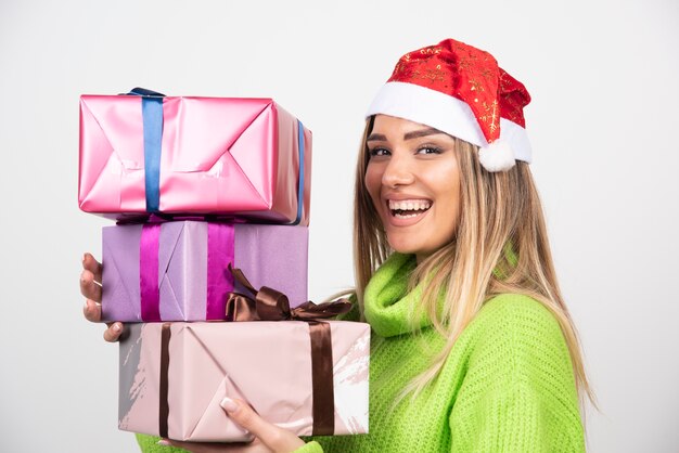 Young woman holding in hands festive Christmas presents.