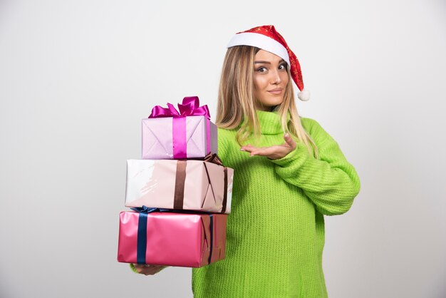 Young woman holding in hands festive Christmas presents