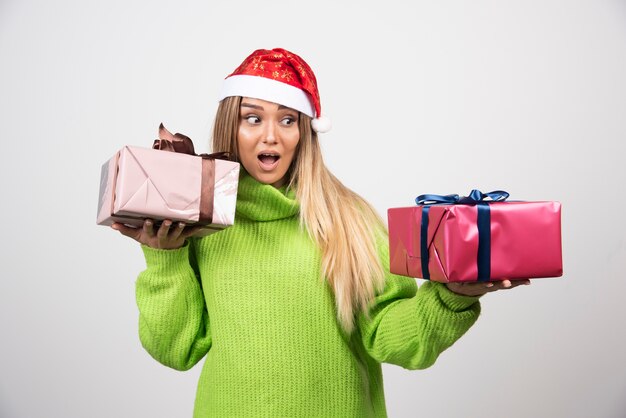 Young woman holding in hands festive Christmas presents