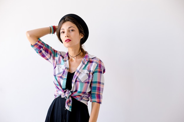 Young Woman Holding Hat With Right Arm