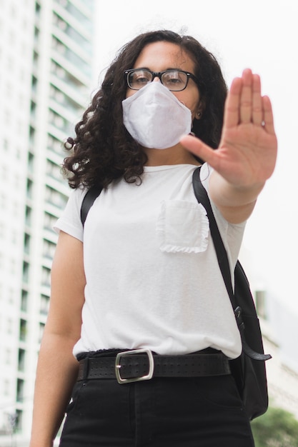 Free photo young woman holding her arm in front of her